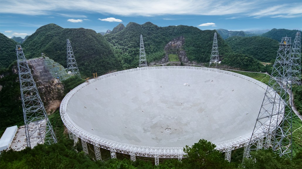 This image shows the Five-hundred-meter Aperture Spherical Telescope, a radio dish surrounded by lush vegetation. It helped identify the potential dark galaxy.