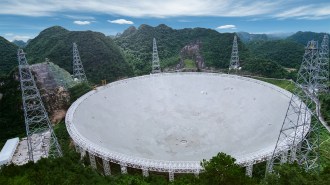 This image shows the Five-hundred-meter Aperture Spherical Telescope, a radio dish surrounded by lush vegetation. It helped identify the potential dark galaxy.