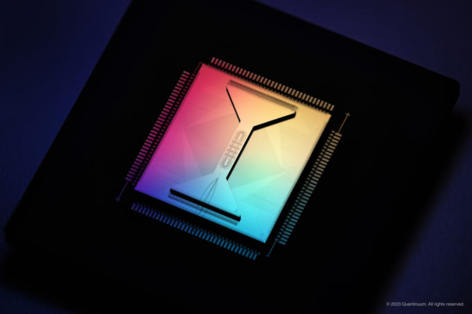 A rainbow-hued quantum computing chip sits on a black background.