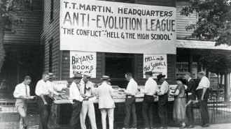 A black-and-white photograph showing people browsing books at a an Anti-Evolution League stand in Dayton, Tenn., where the Scopes trial took place in 1925