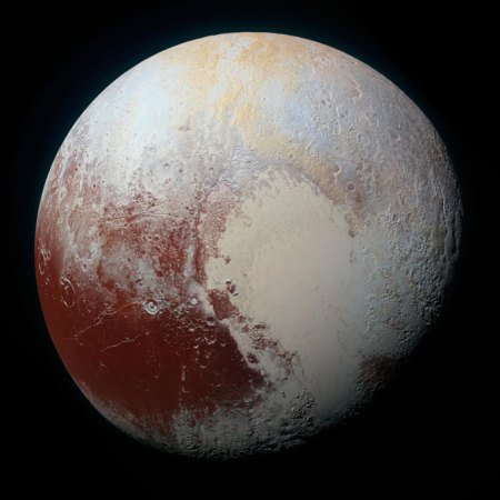 Image of Pluto, with a reddish bottom left side and the heart-shaped region on the right.