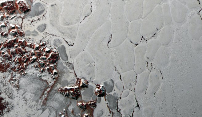 Large polygons on the surface of the nitrogen ice that makes up Sputnik Planitia.