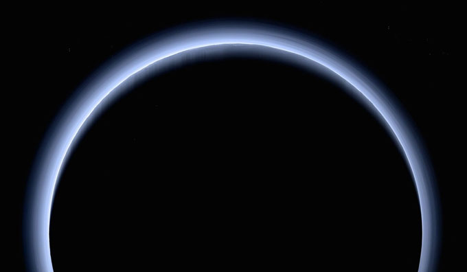 Layered rings of hazy blue show Pluto's atmosphere.