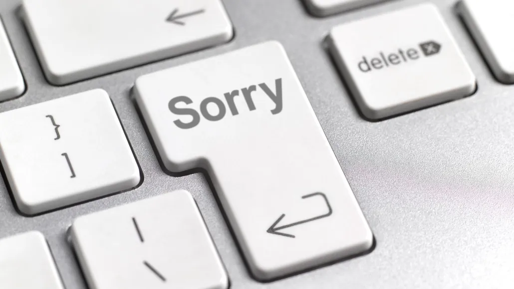 An image of a computer keyboard with a return button that says sorry