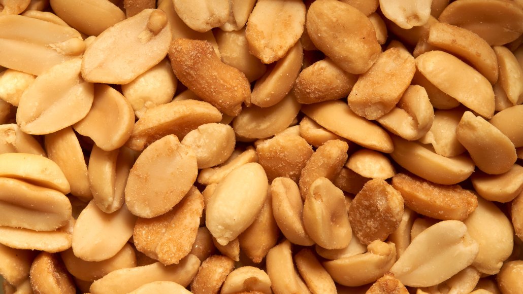 A close-up view of brown, roasted peanuts.