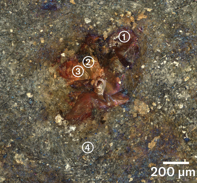 Close up of the weathered basalt showing a rust-colored spot within the gray rock body. It's labeled with the four locations studied with the new analysis tool.