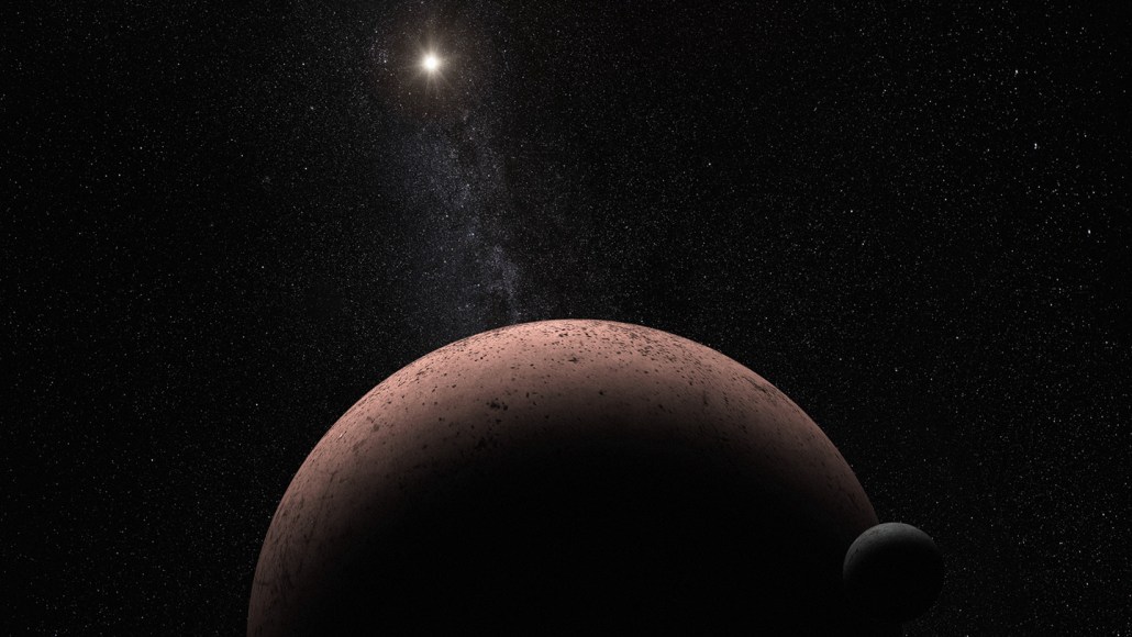 An artist’s rendering of the dwarf planet Makemake with its small moon in the foreground. The reddish, pitted surface of Makemake is partially in shadow. The sun, seen as a bright star, and the faint band of the Milky Way stretch across the background.