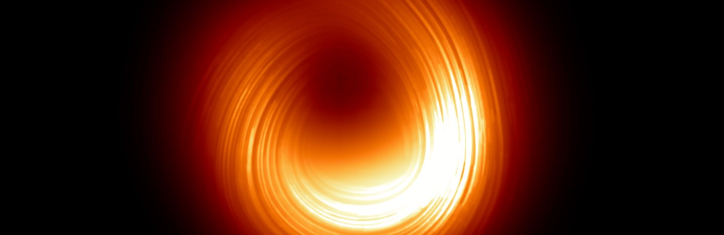 A black hole is shown as a collection of glowing orange and red swirls around a darker center.