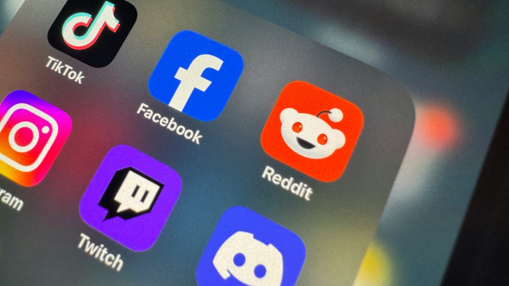 Several social media app icons on a screen, including ones for Reddit, Facebook and TikTok.