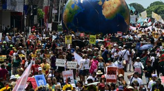 Protestors march outside of COP30 in Brazil