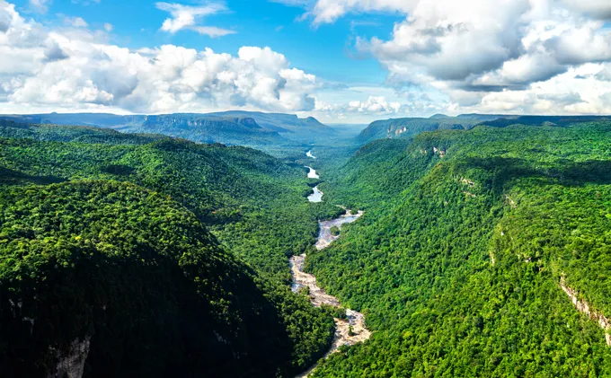 Birds eye view of the Potaro River winding through a lush valley in the Amazon watershed