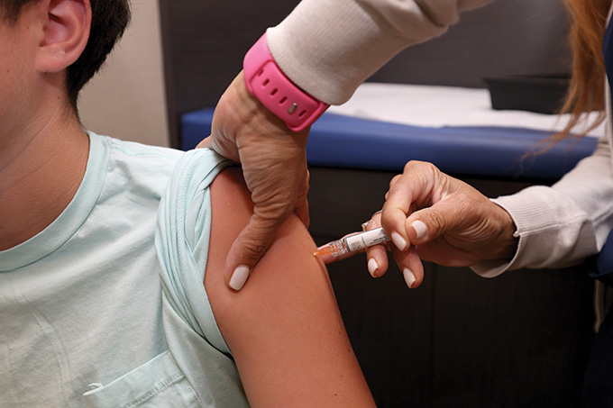 A person administering a vaccine. 