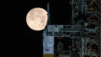 A rocket in front of a full moon