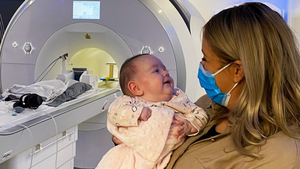 Baby with MRI in the background