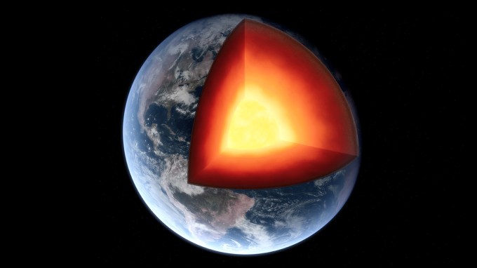 The Earth is shown with an eighth of it's mass removed to reveal its layered interior.