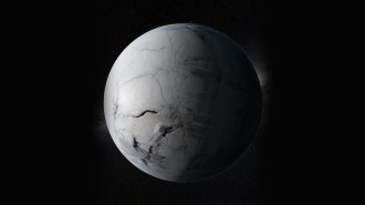 An illustration shows a frozen, ice-covered Earth with dark cracks across its surface set against the blackness of space.