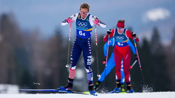 Two women skiing in the mountains of Italy.