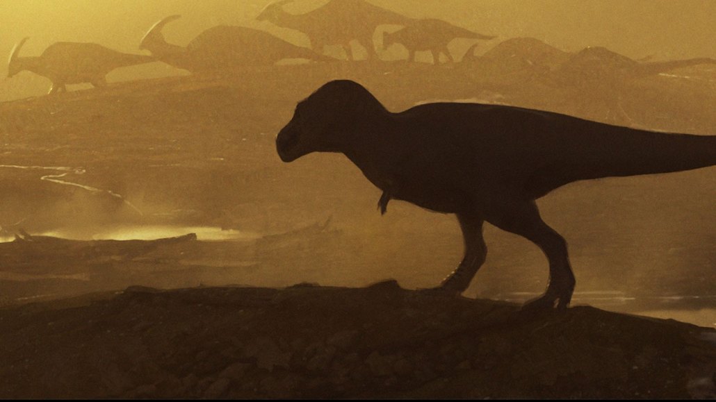 A large tyrannosaur, possibly a T. rex ancestor, stomps near a herd of duckbill dinosaurs in this artist’s conception of a scene from around 74 million years ago.