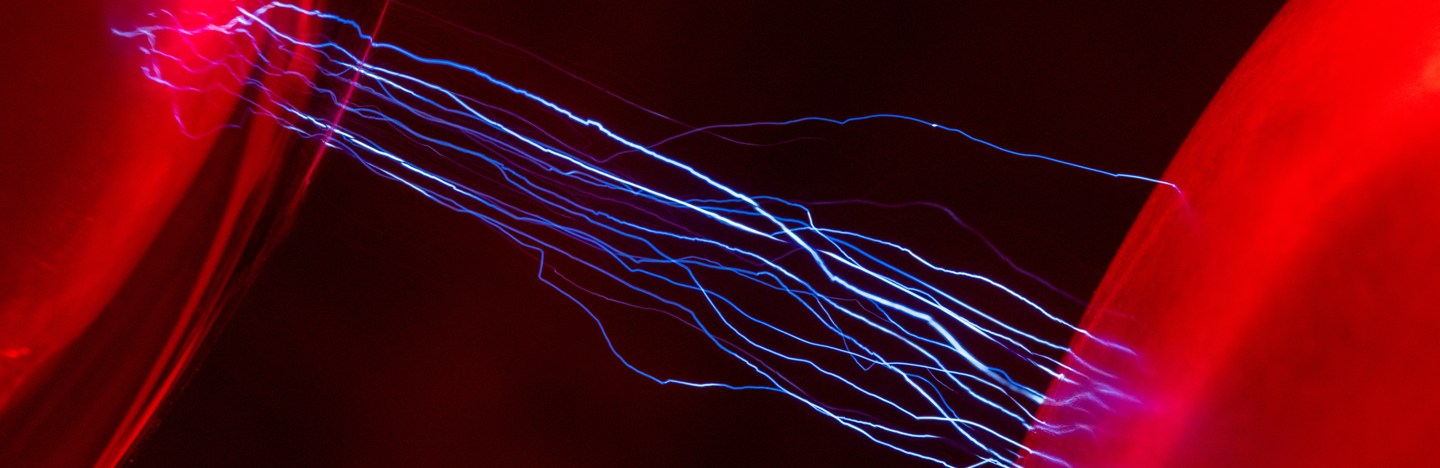 Two red orbs glow as blue lines of electricity zap between them