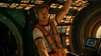 Ryan Gosling sits in a space shuttle's command center