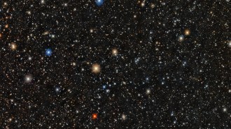 A dense star field shows thousands of stars of varying colors and brightness scattered across a dark background.
