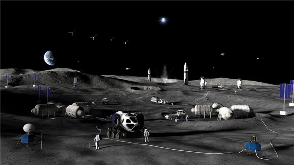 A moonscape is shown littered with the components of a moon base.
