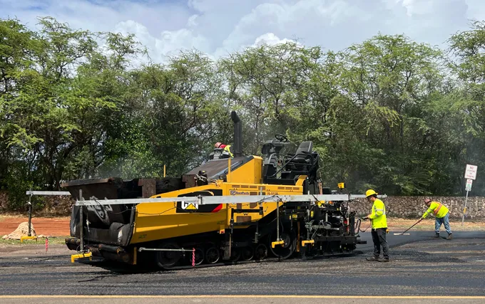 A road crew works on pavement in Hawaii. 