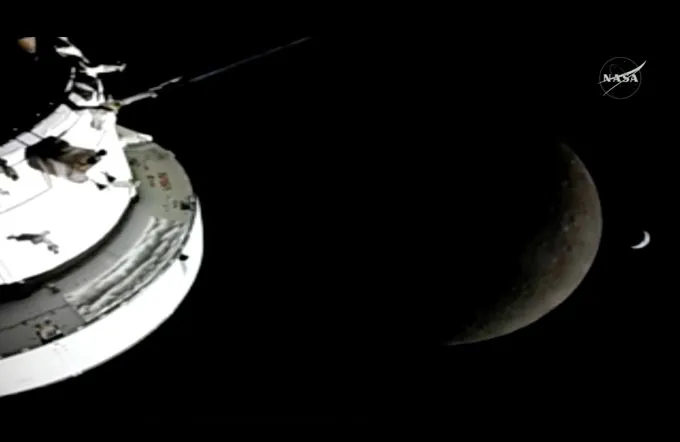 This view from Orion just as it disappeared behind the moon shows both the moon and Earth as crescents.