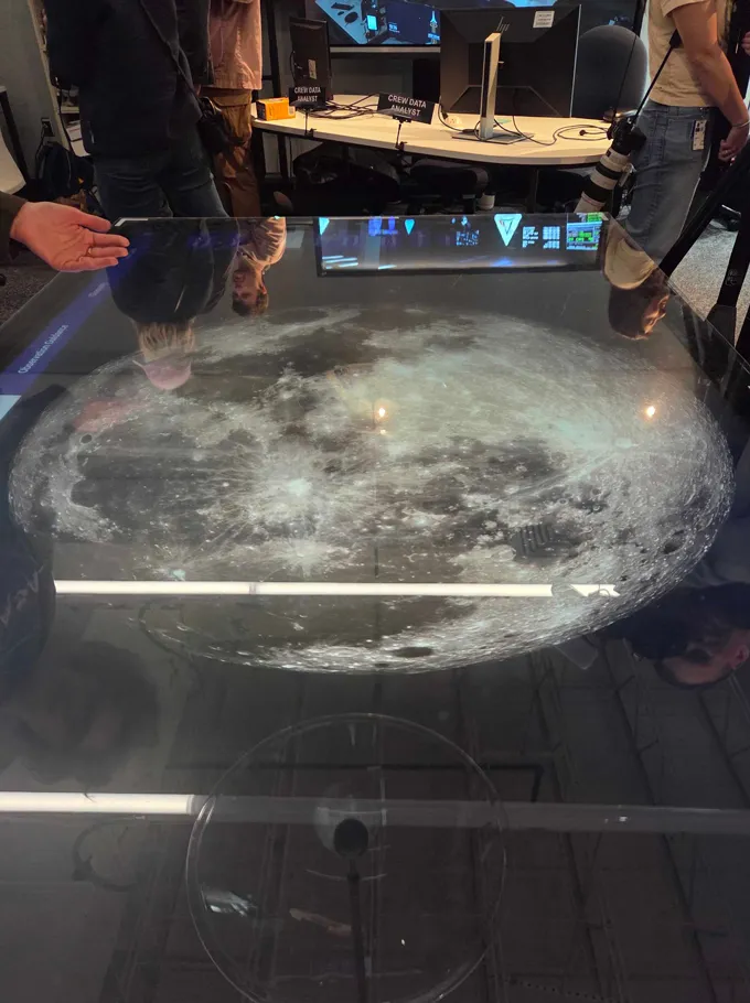 An image of the moon appears within a table top.