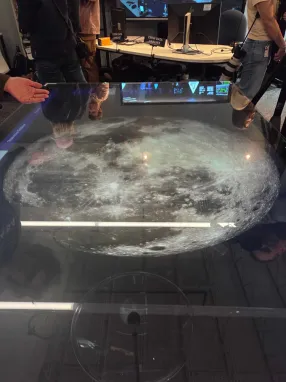 An image of the moon appears within a table top.