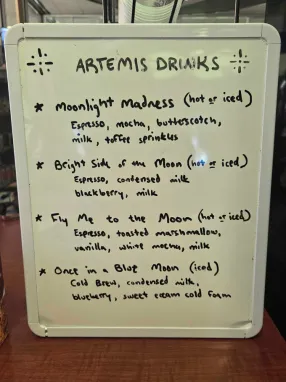 A drink menu shows options like moonlight madness, in honor of the Artemis II mission.