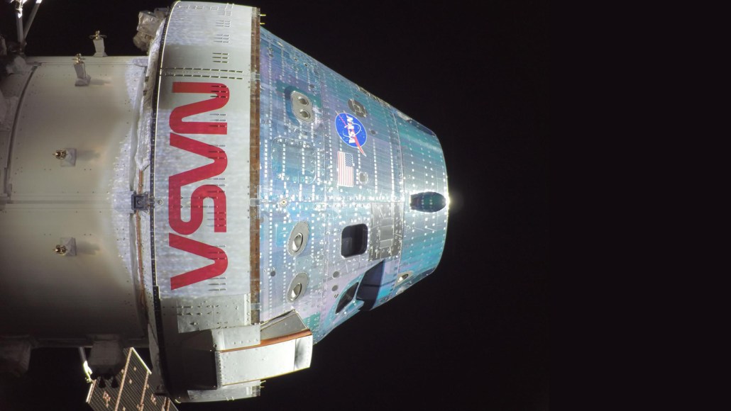 A selfie closeup of the Artemis II Orion capsule on a dark space background