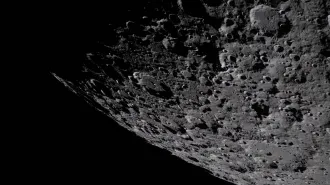 The craggy, cratered surface of the moon with deep shadows