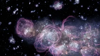 An illustration shows early galaxies filled with bright stars and surrounded by wispy clouds of gas.