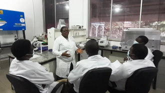 Margaret Oluwatoyin Japhet talks to her lab members