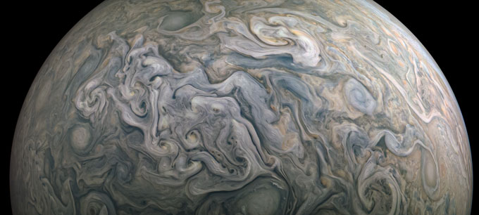 Swirling cloud patterns cover Jupiter’s atmosphere in a close-up view.
