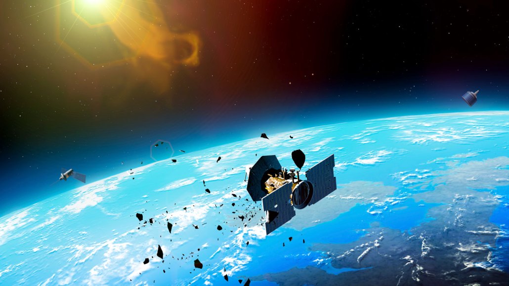 An illustration of Earth from space, showing satellites and debris fragments that are orbiting the planet, with the sun visible in the background.
