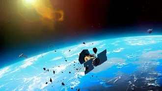 An illustration of Earth from space, showing satellites and debris fragments that are orbiting the planet, with the sun visible in the background.