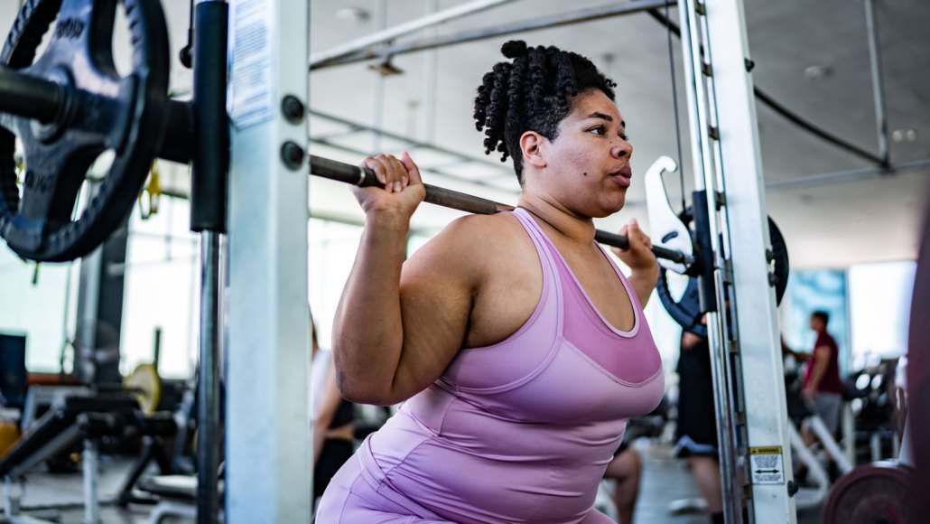 A woman lifts weights, a type of friction worth keeping.