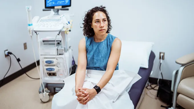 A women sits in a health clinic