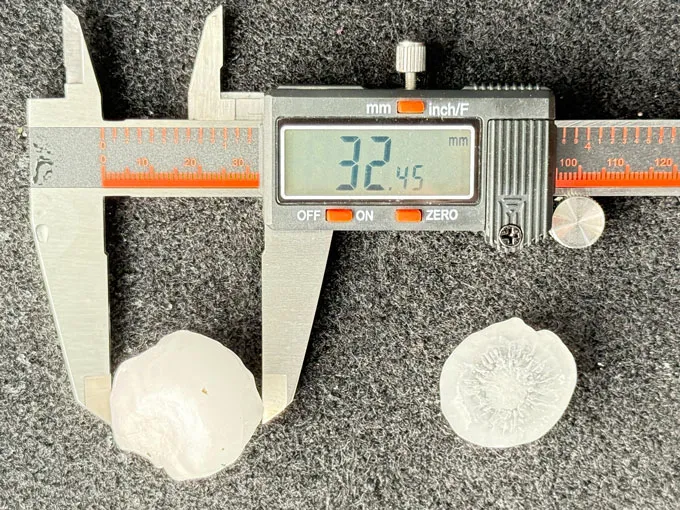 A large hailstone in a measuring device