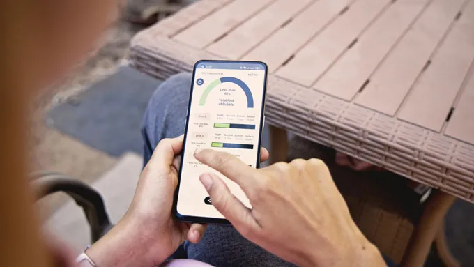 A phone app someone is using with different charts on the screen