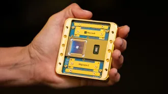 A hand holds a square quantum computing chip with the name Majorana 2 on it.