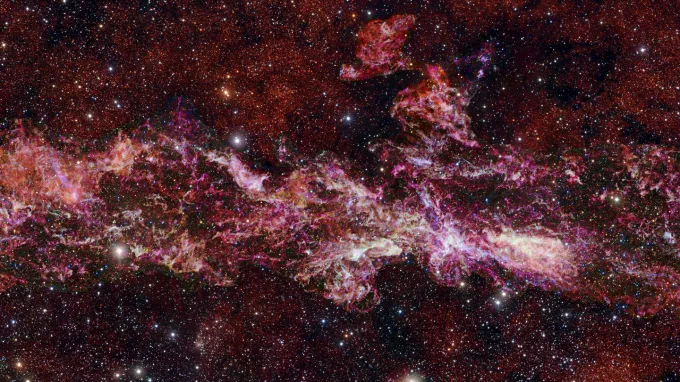 A star-laden strertch of our galaxy at the heart of the Milky Way. Pinpoints and smears of light are seen on a dark background.