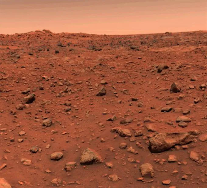 A photograph of the Mars landscape, showing a very rocky and red field.