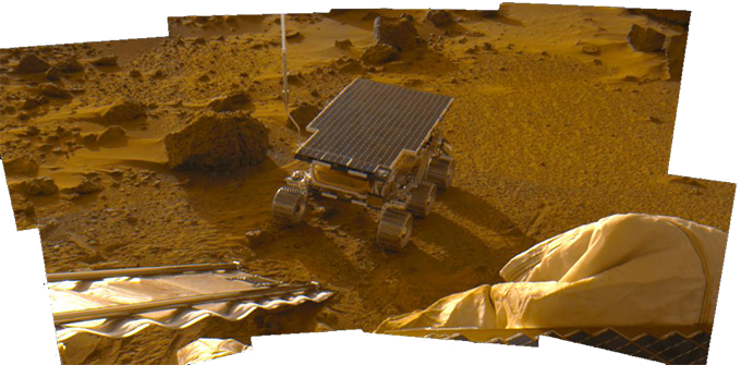 A photo of Sojourner among a dusty, orange-tinted landscape.
