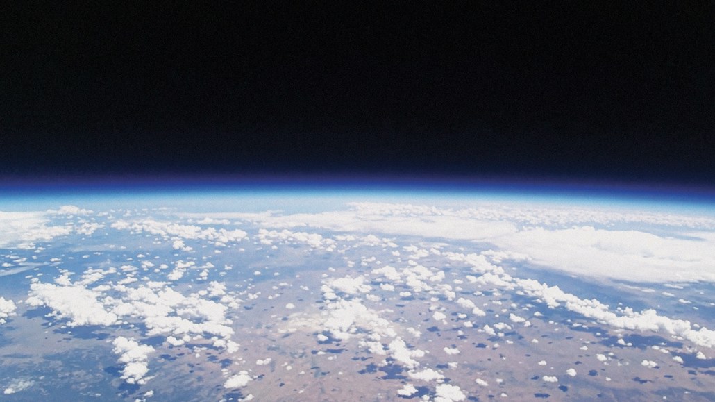 View of part of earth from outer space showing the stratosphere, which is a gray zone between Earth and space.