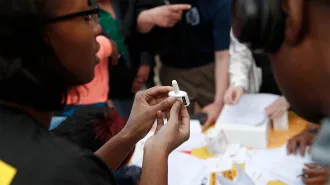A health worker demonstrates how to use the opioid antidote naloxone nasal spray