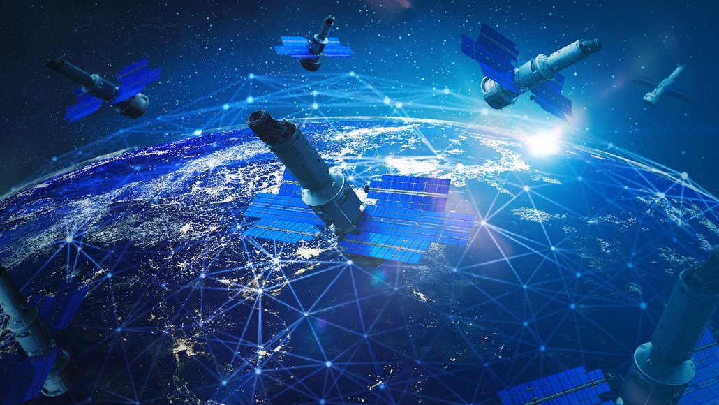 An illustration showing a cluster of satellites orbiting above Earth.