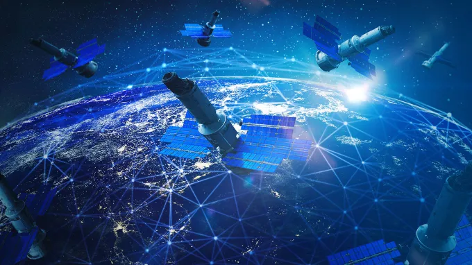 An illustration showing a cluster of satellites orbiting above Earth.
